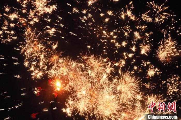 灼熱的鐵水在空中迸散。在空中形成“鐵花火雨”的景象，似天女散花，似群星漫天，如夢如幻，美不勝收。侯奇志 攝</p>
<p>